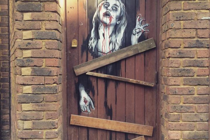 Jack the Ripper Tour door image with scary woman bleeding from her lips on it