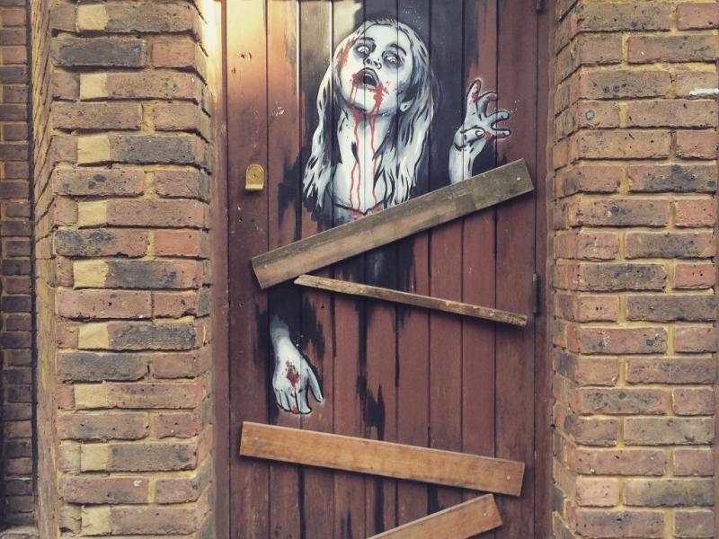Jack the Ripper Tour door image with scary woman bleeding from her lips on it